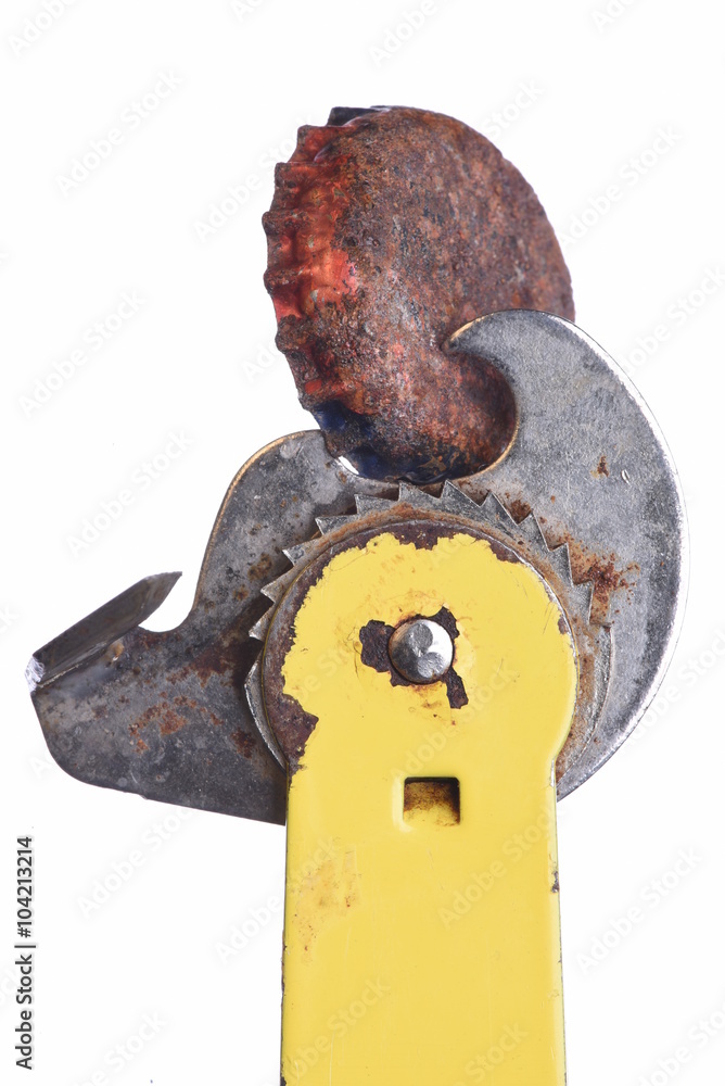 Old rusty can bottle with can opener tool isolated on white background Old rusty can bottle with can opener tool isolated on white background