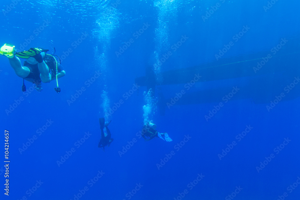 Group of Divers near Boat Underwater Group of Divers near Boat Underwater