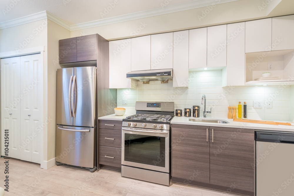 © karamysh - Modern, bright, clean, kitchen interior with stainless steel appliances in a luxury house © karamysh - Modern, bright, clean, kitchen interior with stainless steel appliances in a luxury house
