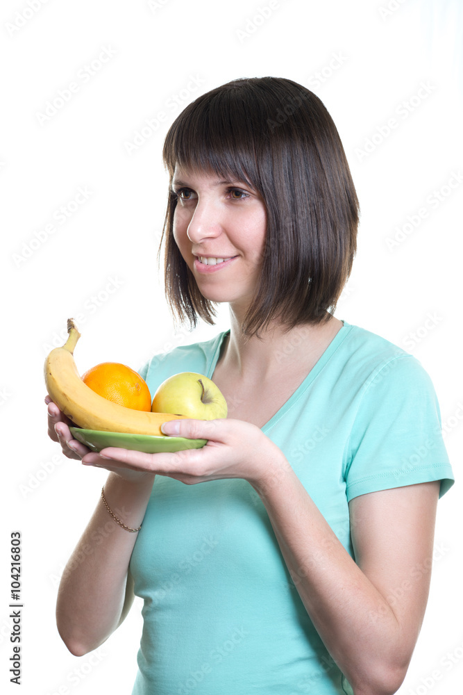 Healthy eating. Girl holds a dish with fruits, isolated on a white background