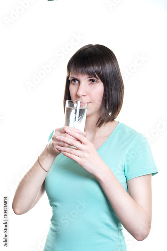 Healthy eating. A girl holding a glass of water, isolated on a white background