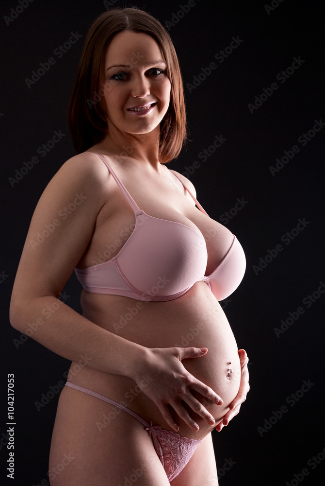 Proud and attractive pregnant mother posing at studio professional shadow  shoot for pregnancy body art wearing sexy lingerie Stock Photo | Adobe Stock