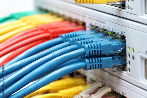 organized cables connected in network switch in data center. Int