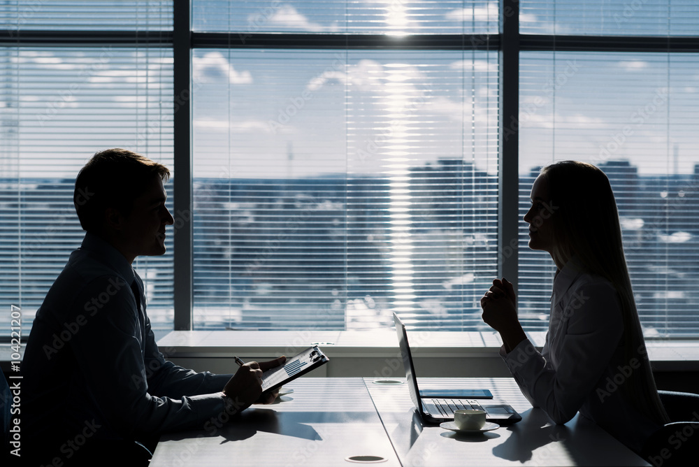 Fototapeta premium Outlines of two businessmen working late in office