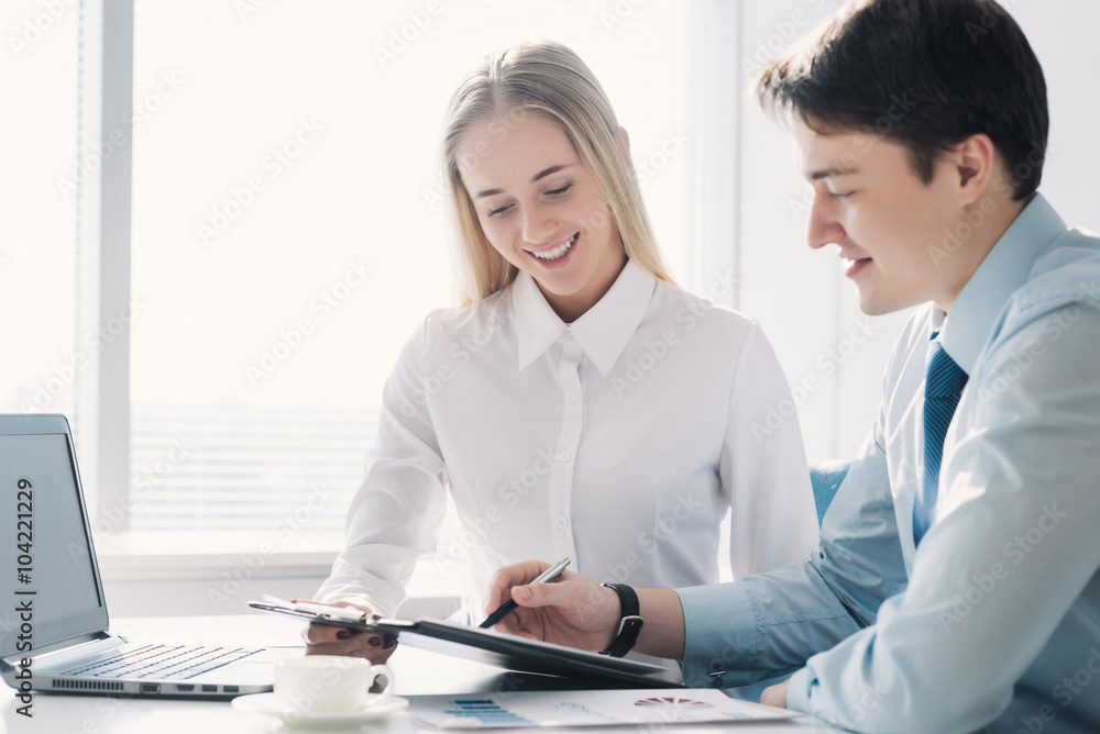 Two colleagues discussing a business project, a man and a woman Two colleagues discussing a business project, a man and a woman