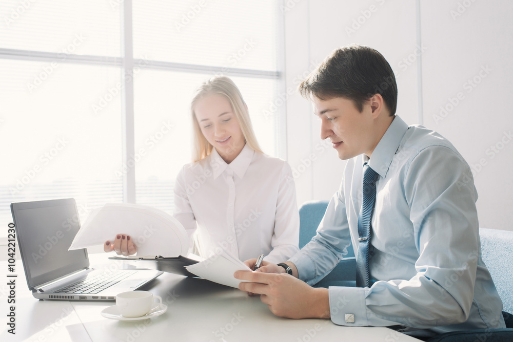 Two colleagues discussing a business project, a man and a woman Two colleagues discussing a business project, a man and a woman