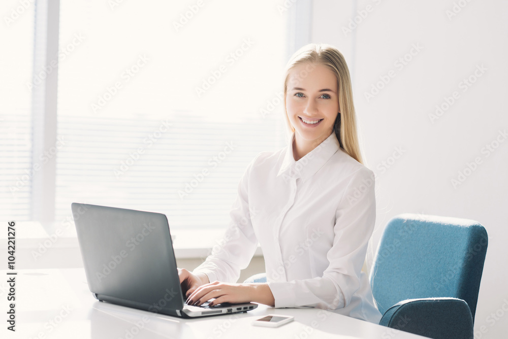 Young businesswoman looking at camera with toothy smile Young businesswoman looking at camera with toothy smile