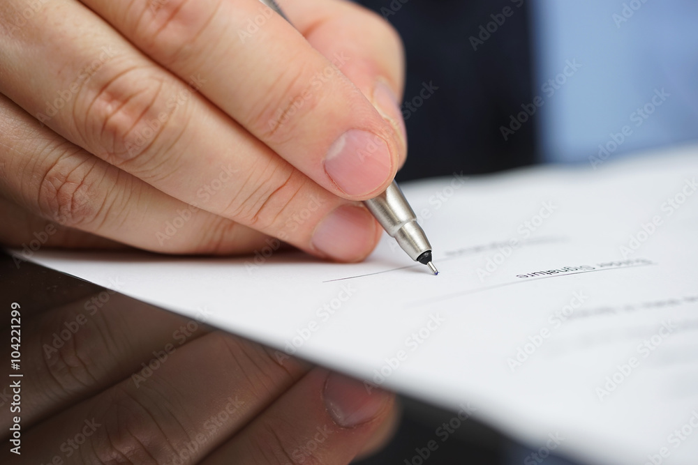 businessman in blue shirt and tie signing contract businessman in blue shirt and tie signing contract