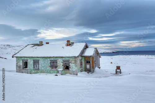 Old abandoned house on the Kola Peninsula near the seaside Barents sea photo