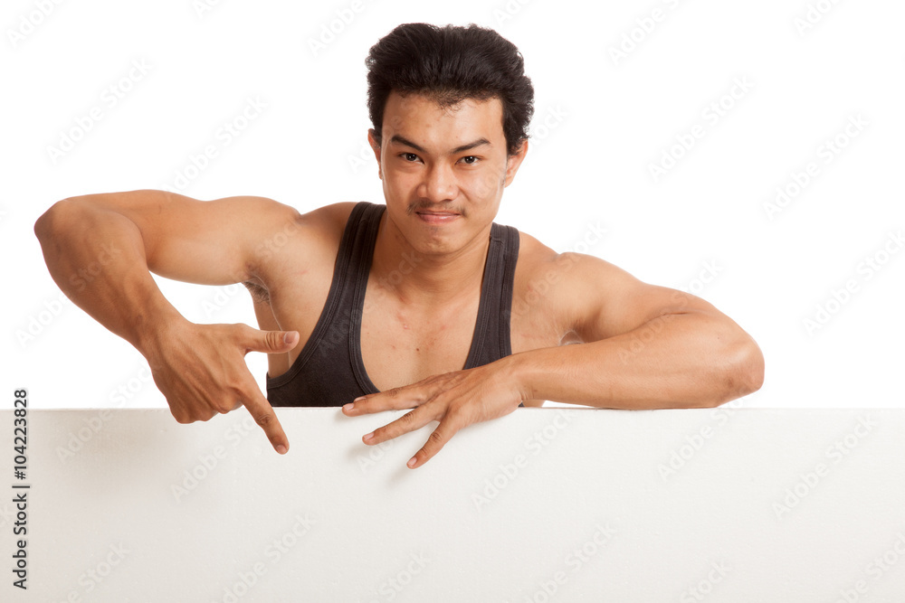 Muscular Asian man point down behind blank sign Muscular Asian man point down behind blank sign