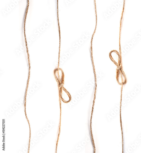 Fototapeta Naklejka Na Ścianę i Meble -  linen rope with bows on white background