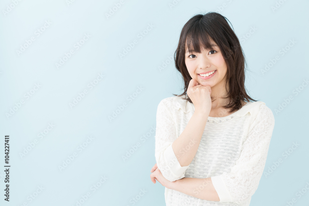 attractive asian woman on blue background attractive asian woman on blue background