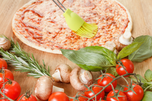 Cooking pizza with fresh ve...
