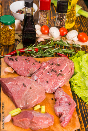 Various raw red meat with flavorings