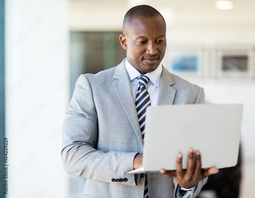 african entrepreneur working on laptop computer