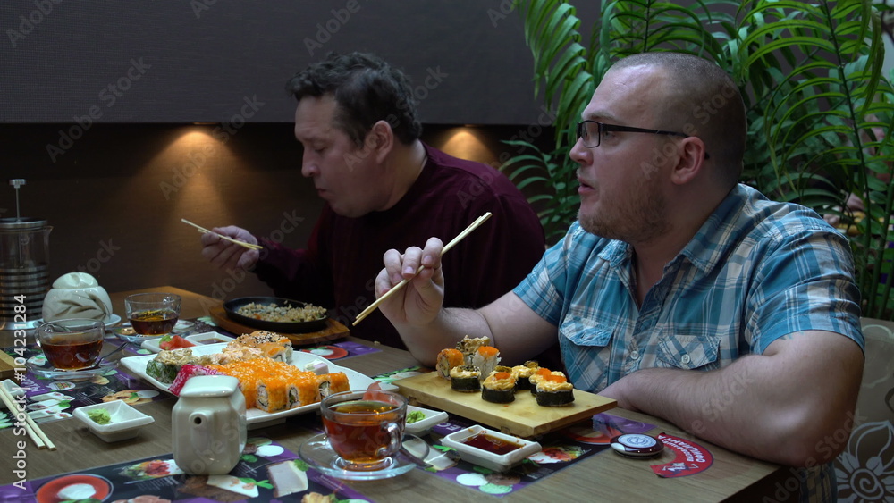 Father and son eating sushi Japanese restaurant Father and son eating sushi Japanese restaurant