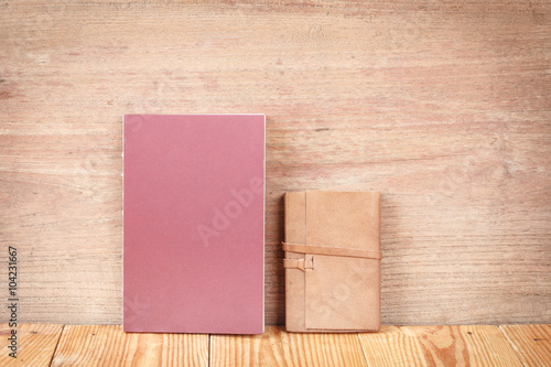 Closed up notebooks on wooden background