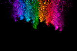 Falling colored powder isolated on black background
