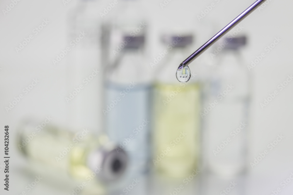 Needle of syringe with ampules on white background Needle of syringe with ampules on white background