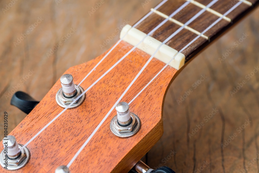 Close up of wooden ukulele on rusty wooden background - copy space
Close up of wooden ukulele on rusty wooden background - copy space