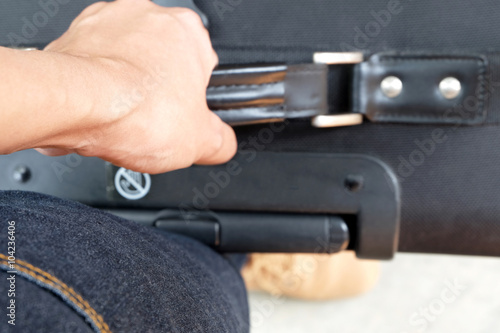 Tendons (selected focus) at wrist while carrying a black baggage