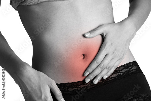 Woman holding her stomach with red highlighted area.