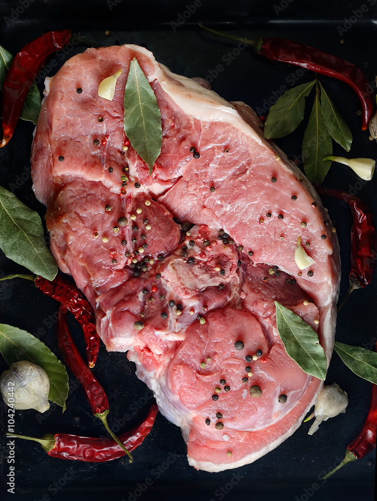 Fotografie raw meat on a black background with spices