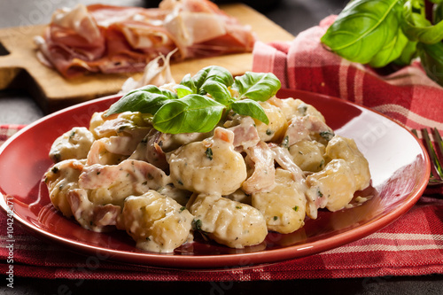Potato gnocchi, Italian potato dumplings with cheese sauce, ham