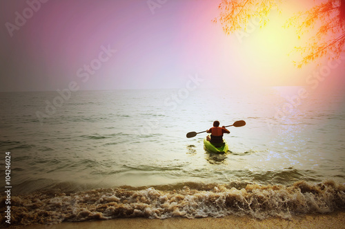 Skinhead Caucasian man on kayak on beach in summer / Skinhead Caucasian man on kayak on ocean near beach start new adventure in summer