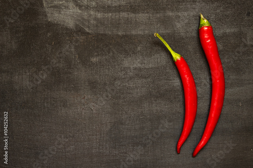 Red hot peppers on black background