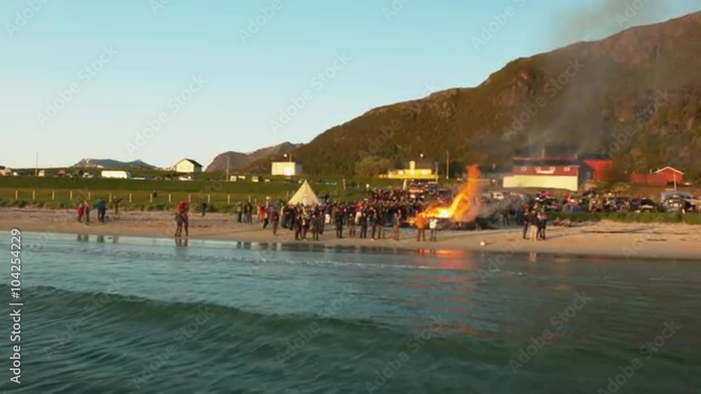 Aerial drone shot of a fire at beachparty Aerial drone shot of a fire at beachparty