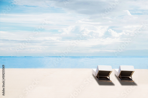 The beach in summer, clear sand and blue sky with beach chairs, idyllic travel background