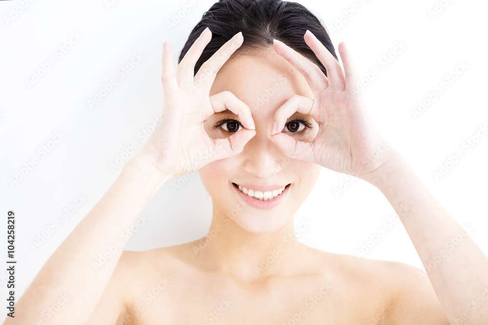 Closeup of young smiling woman eyes with gesture Closeup of young smiling woman eyes with gesture