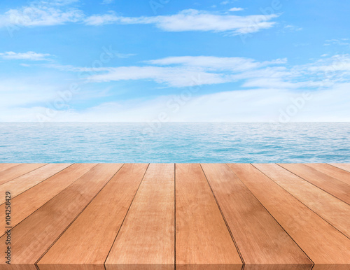 Wood table top on blue sea and sky background