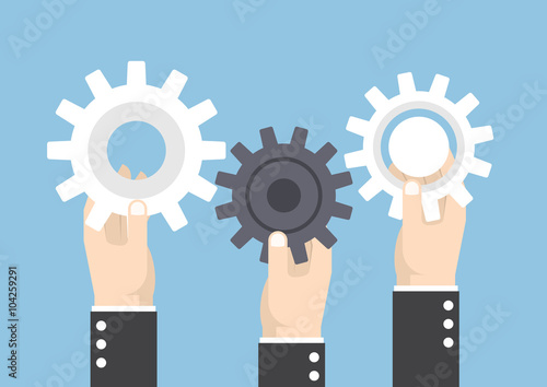 Hands holding gear or cog wheel, teamwork, effective team concep