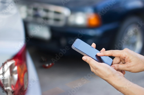 woman using smartphone at roadside after car accident, soft