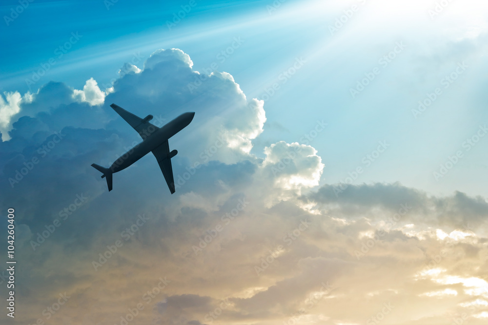 Naklejka premium Samolot na niebie i chmura o wschodzie słońca