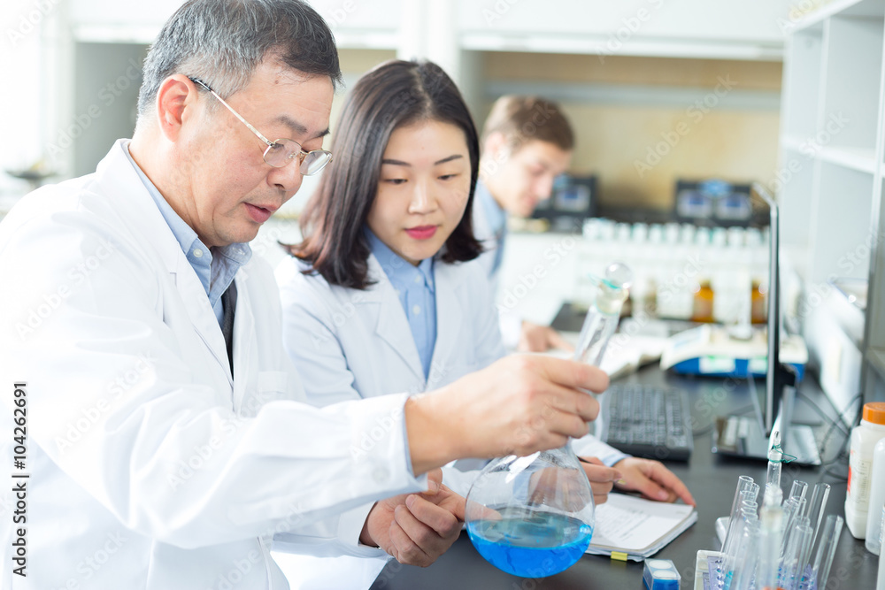 people doing chemical experiment in modern lab people doing chemical experiment in modern lab