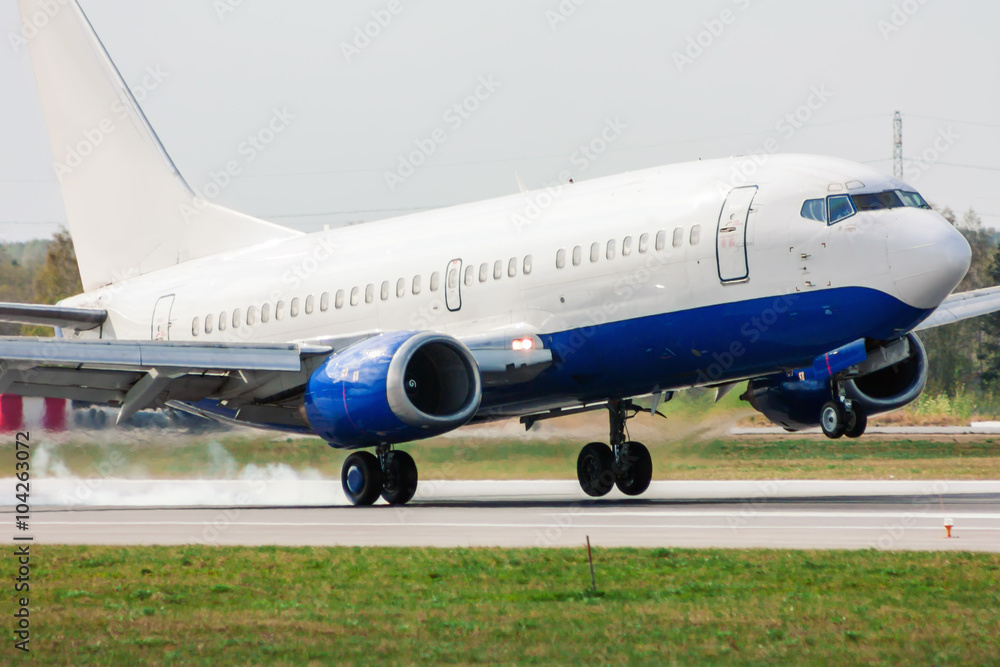 Airplane landing on runway. Touchdown with tire smoke