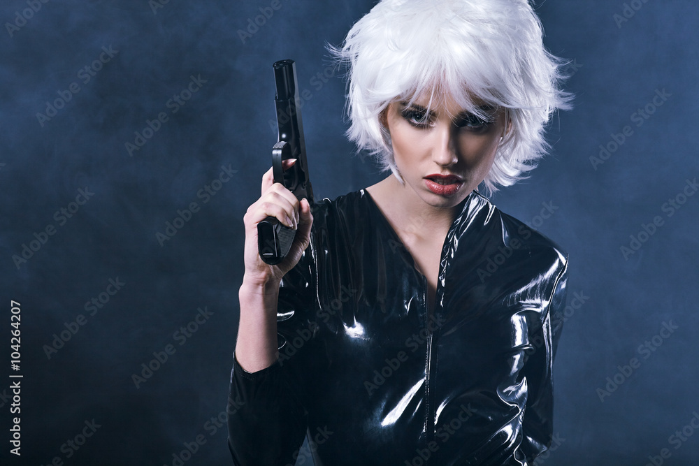 beautiful sexy girl holding gun . smoke background beautiful sexy girl holding gun . smoke background