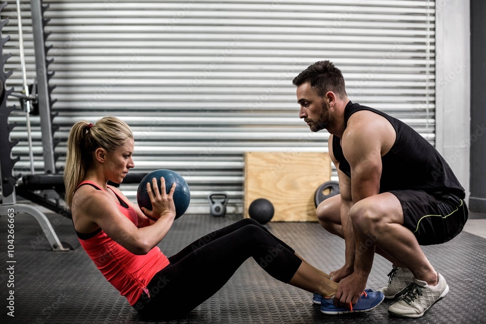 Fit couple doing abdominal ball exercise Fit couple doing abdominal ball exercise