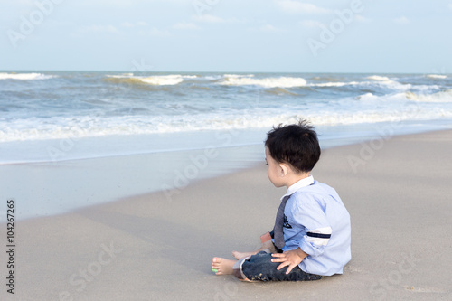 Boy sit on the beach