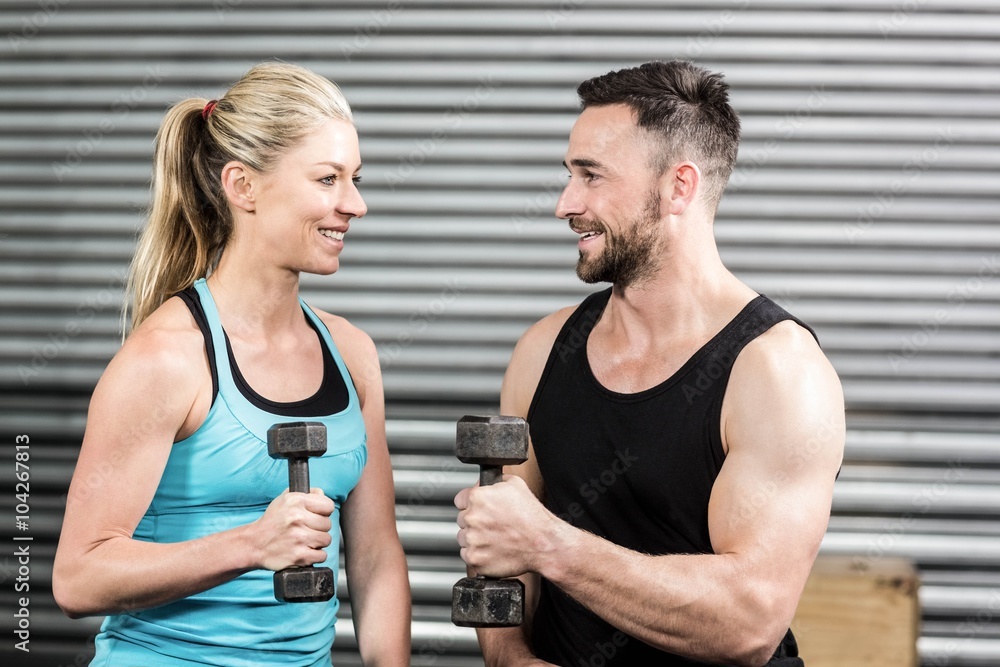 Fototapeta premium Couple lifting dumbbells together