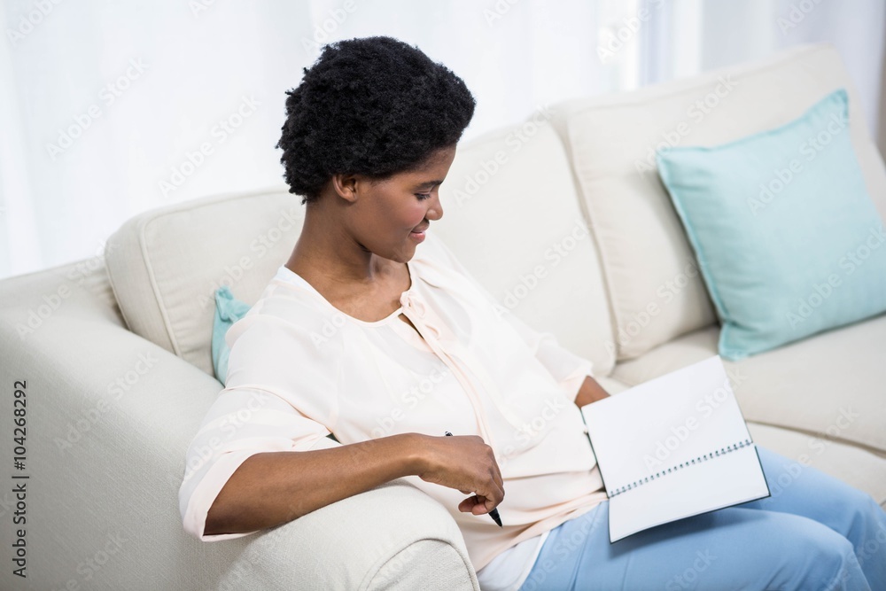 Pregnant woman holding notebook Pregnant woman holding notebook