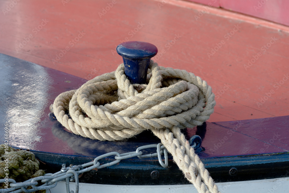 Fototapeta premium Rope tied to mooring post on canal boat