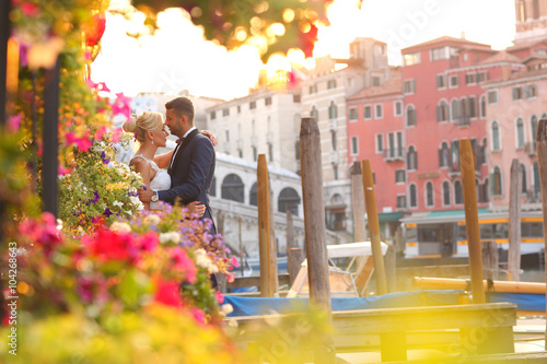 groom and bride kissing in Venice photo