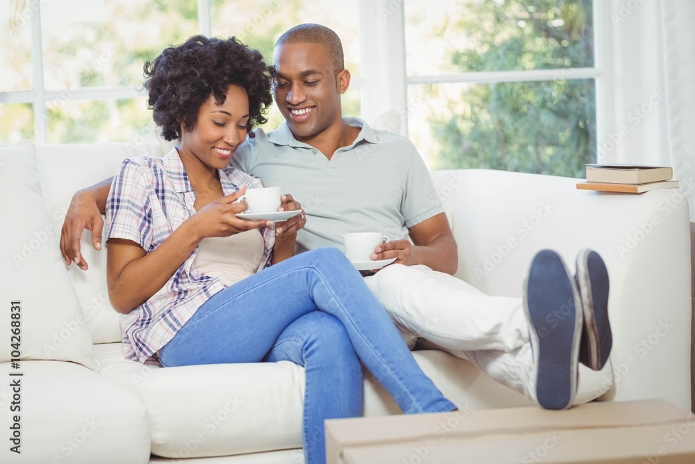 Happy couple on the sofa drinking coffee Happy couple on the sofa drinking coffee