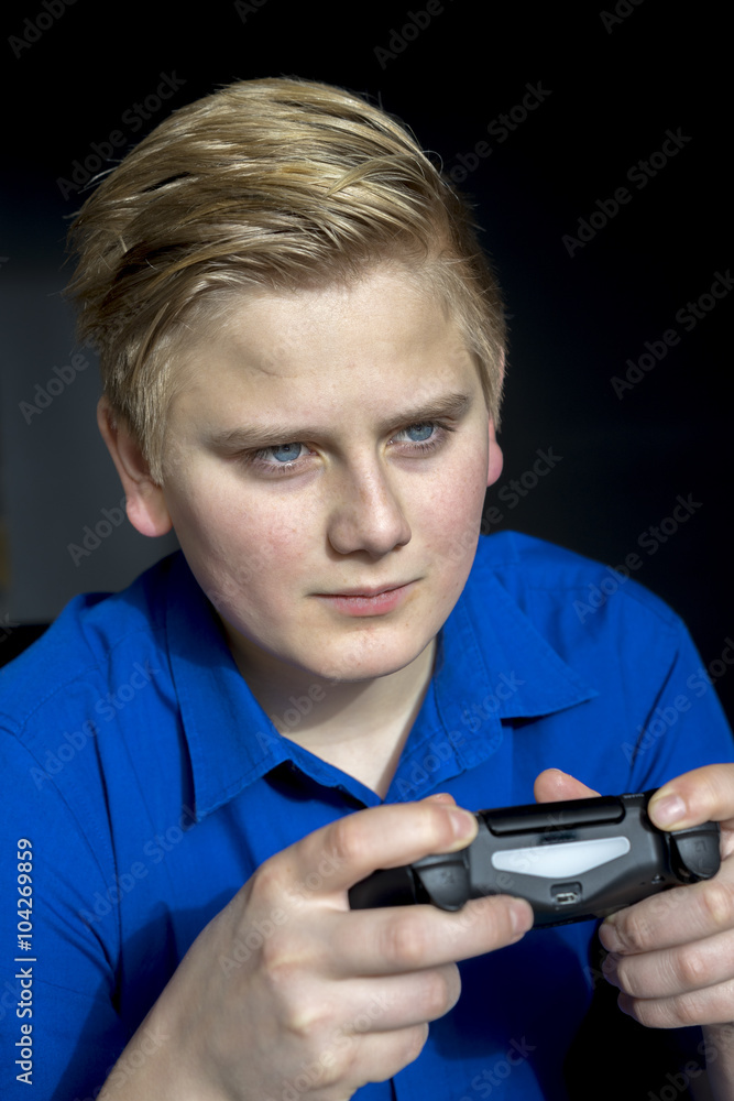 Fototapeta premium Calm teen using game controller joysticks
