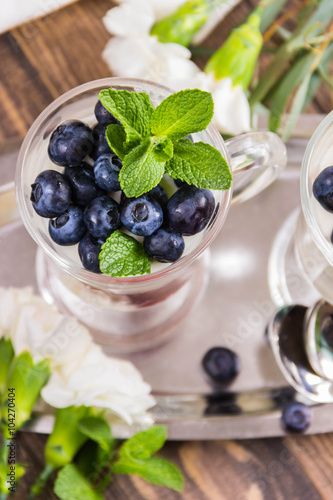 mousse of yoghurt with blueberries and raspberries, and decorated with blueberries and mint