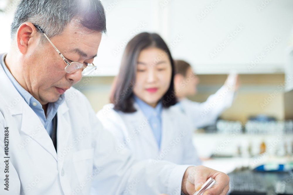 people doing chemical experiment in modern lab people doing chemical experiment in modern lab